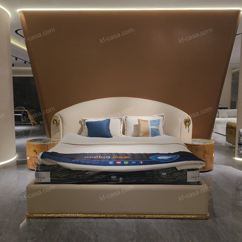 Beige Leather Upholstered Bed with Gold Stainless Steel Elephant Head Accents & Hammered Base Trim